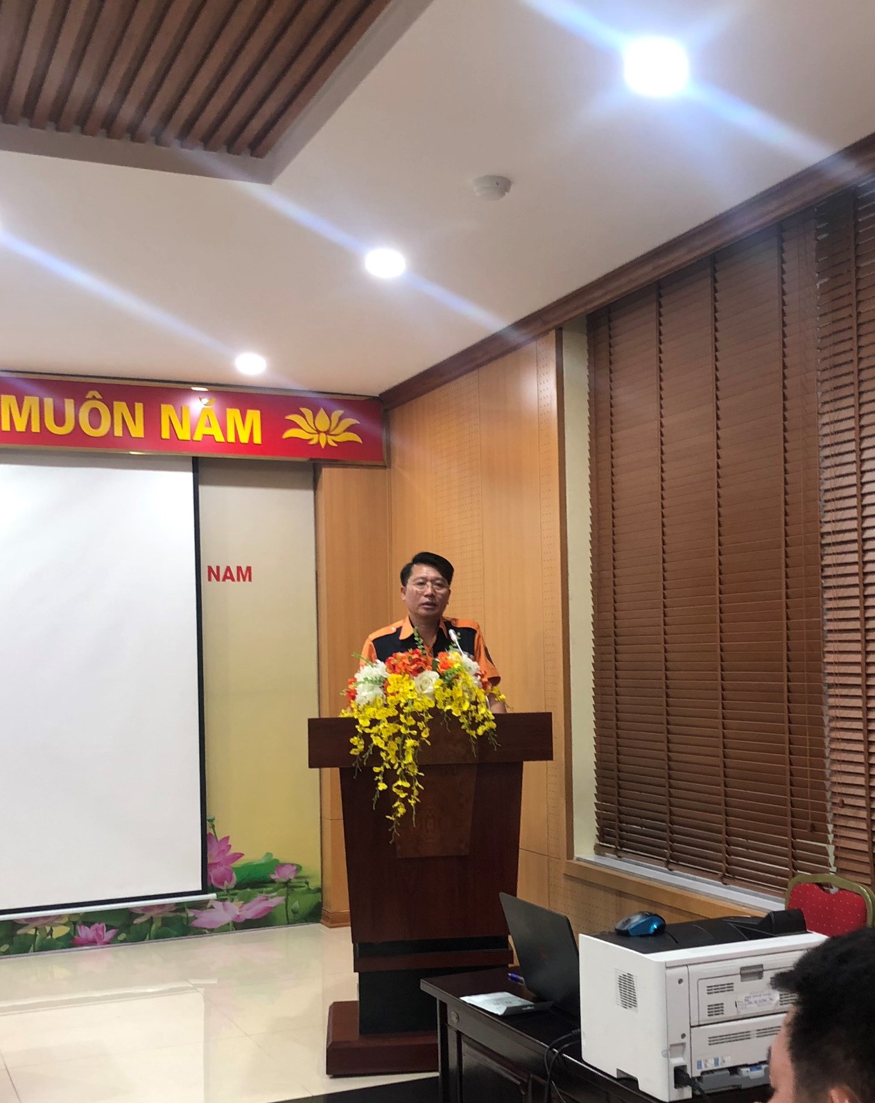 A person standing at a podiumDescription automatically generated with medium confidence